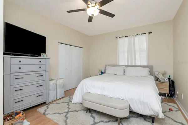 a bedroom with a bed and a flat screen tv