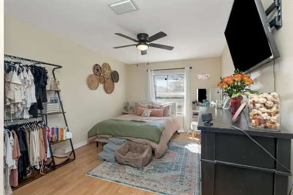 a bedroom with a bed and a flat screen tv