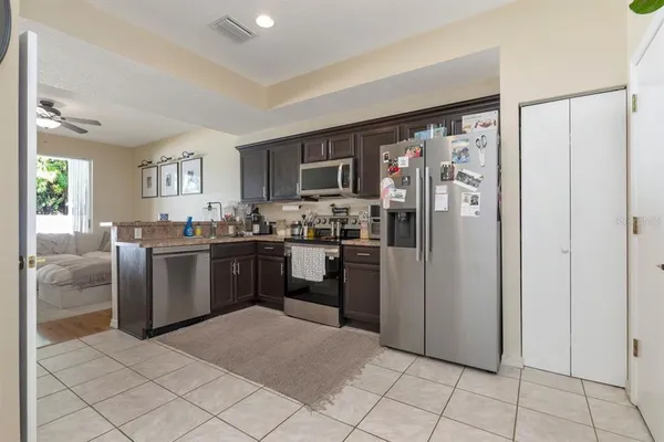 a kitchen with stainless steel appliances granite countertop a refrigerator stove and sink