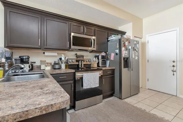 a kitchen with a refrigerator stove and a sink