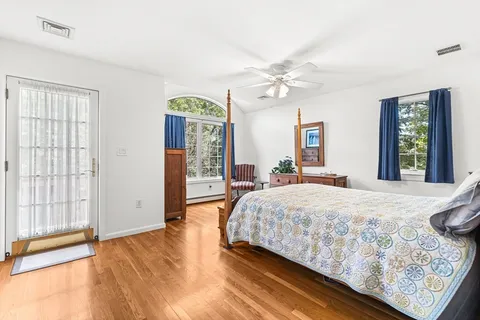 a bedroom with a bed dresser and a window