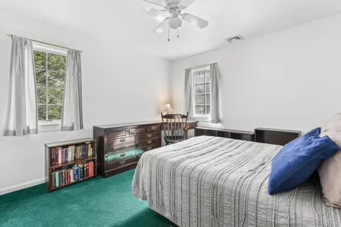 a bedroom with a bed furniture and a window