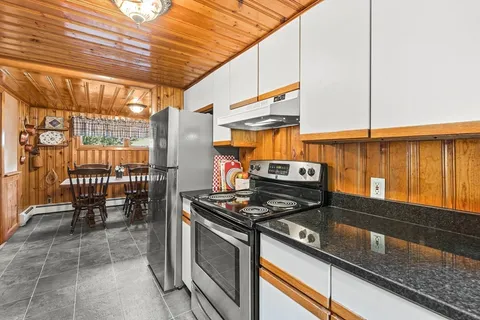 a kitchen with stainless steel appliances granite countertop a stove and a refrigerator