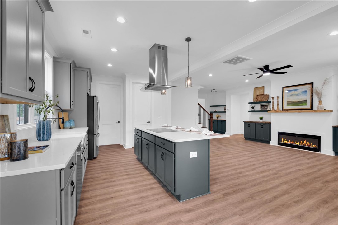 407 Blue Ridge Court Westminster, SC 29693 - Photo 11 of 48 This open concept space features a kitchen island and fireplace, perfect for entertaining.