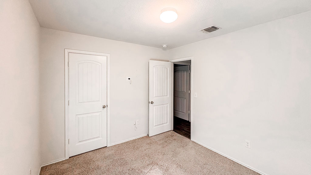 14915 Talus Road Manor, TX 78653 - Photo 14 of 20 Soft carpeting pairs with neutral walls in this versatile secondary bedroom.
