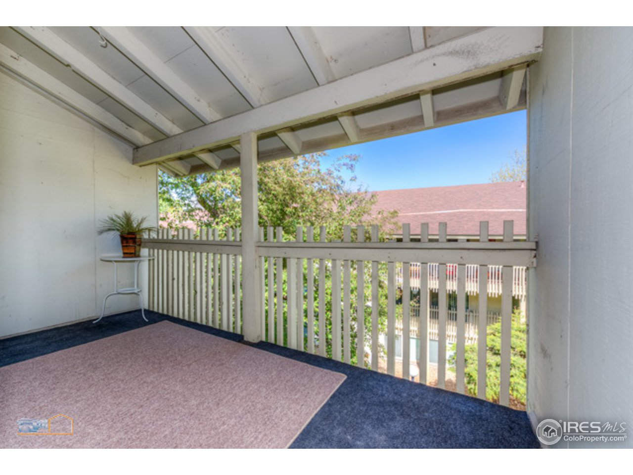 2707 Valmont Road, Unit 306A Boulder, CO 80304 - Photo 4 of 25 a view of an empty room with a floor to ceiling window and wooden floor