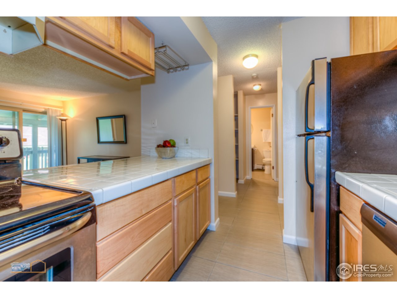 2707 Valmont Road, Unit 306A Boulder, CO 80304 - Photo 8 of 25 a kitchen with stainless steel appliances granite countertop a refrigerator and a sink