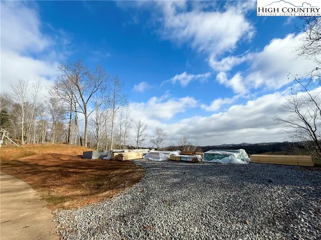 a view of road with large trees