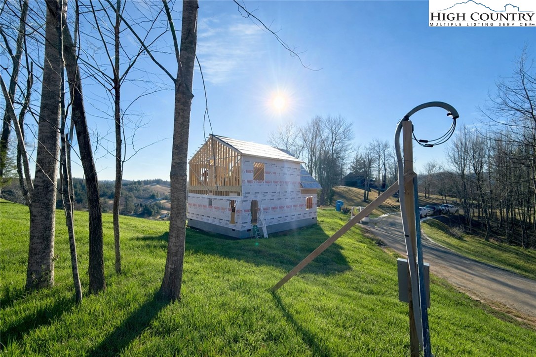 a view of a house with a backyard and a patio