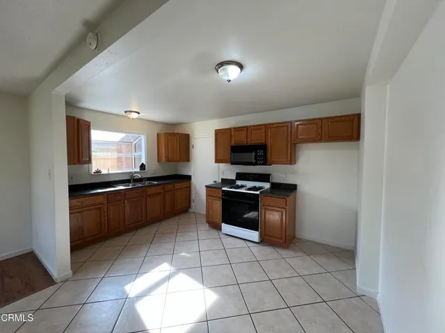 a kitchen with stainless steel appliances kitchen island granite countertop a sink and cabinets
