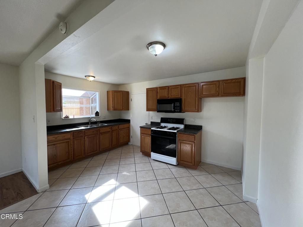 2230 Lassen Street Oxnard, CA 93033 - Photo 8 of 15 a kitchen with stainless steel appliances kitchen island granite countertop a sink and cabinets