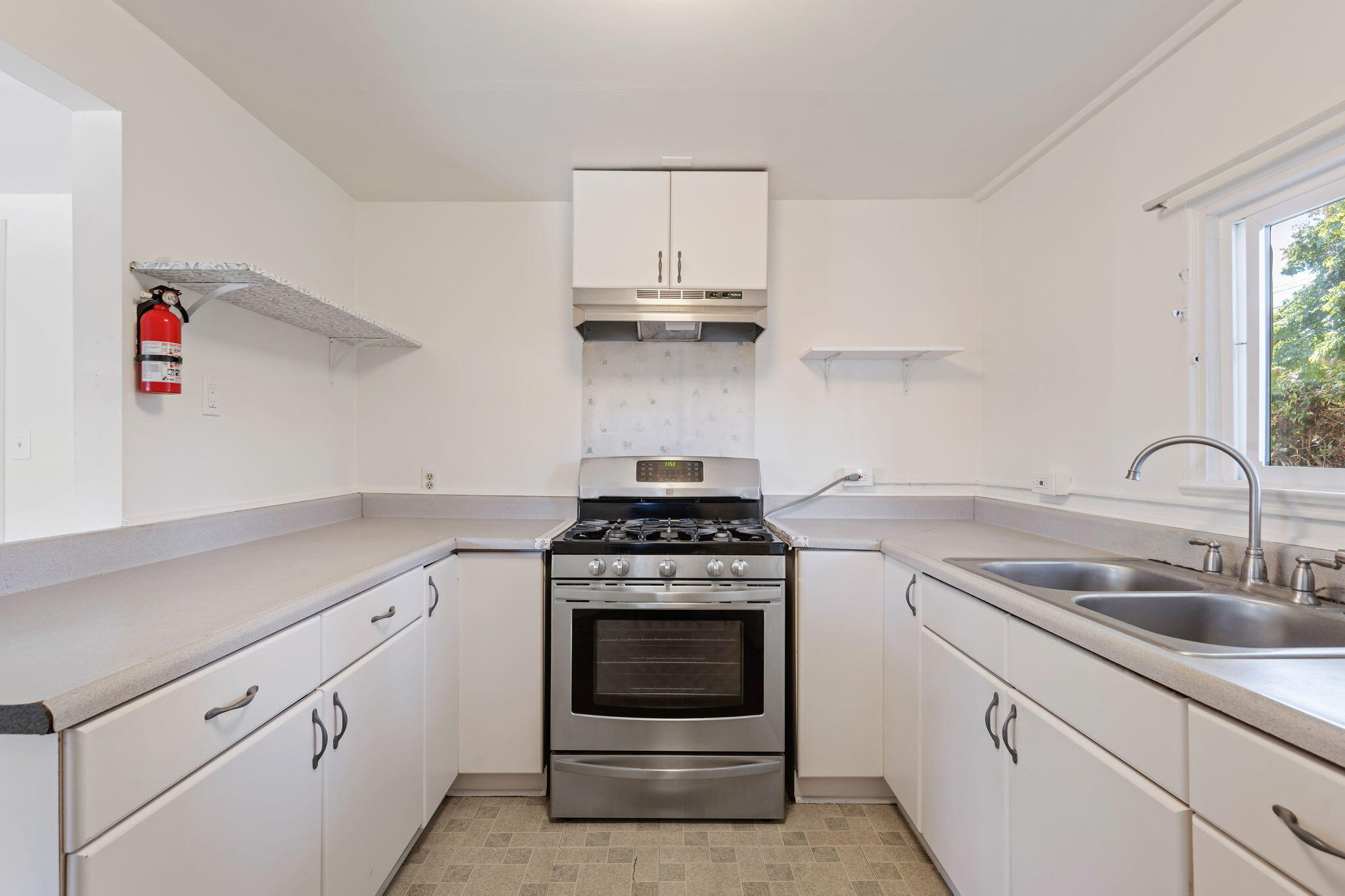 834 West Valerio Street Santa Barbara, CA 93101 - Photo 5 of 12 a kitchen with white cabinets and appliances