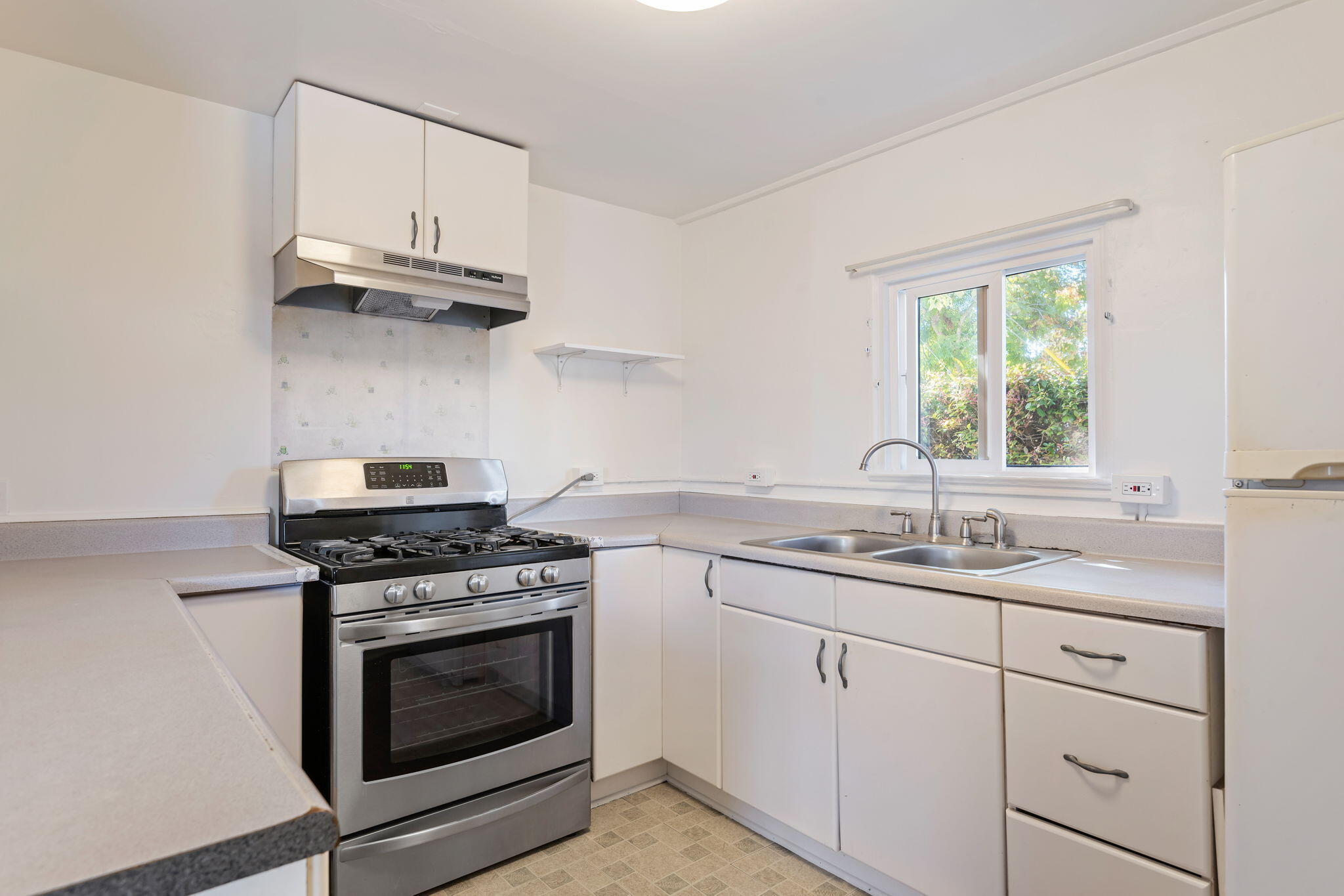 834 West Valerio Street Santa Barbara, CA 93101 - Photo 6 of 12 a kitchen with cabinets appliances a sink and a window
