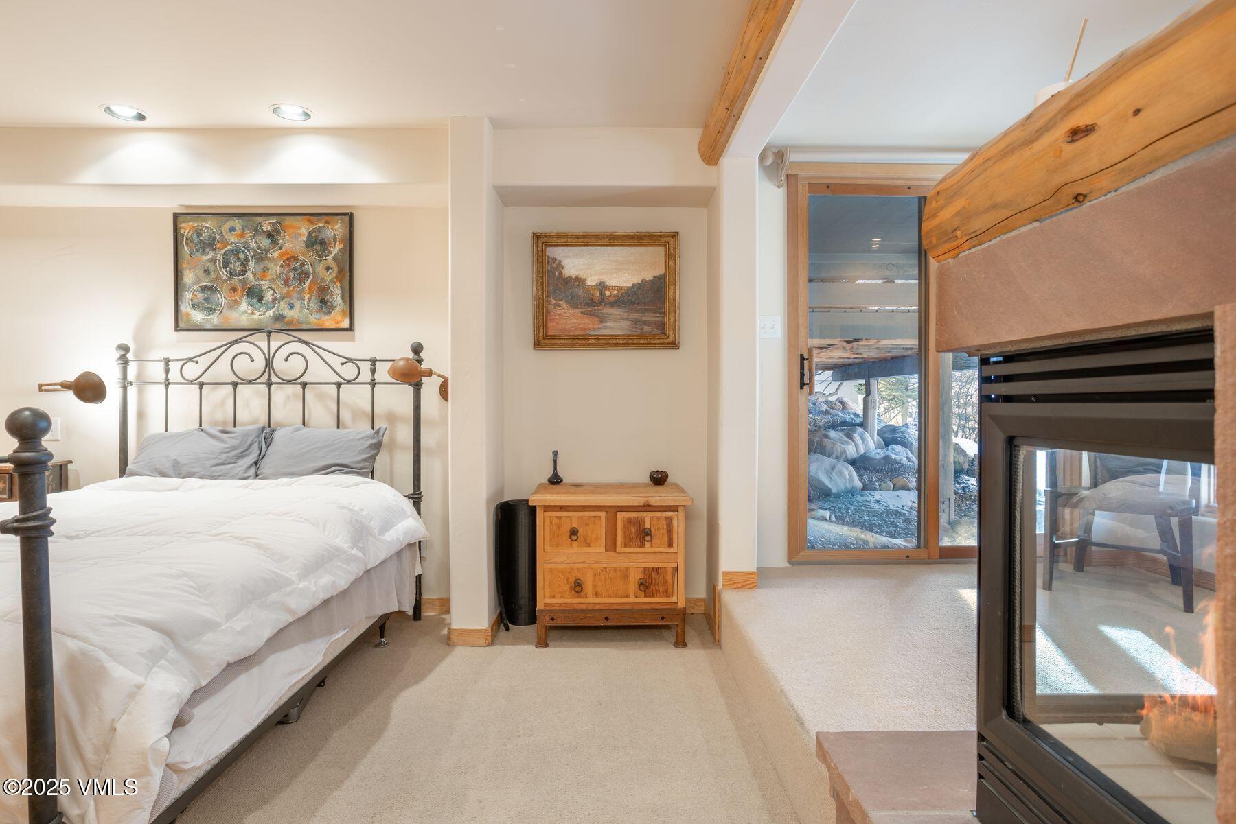 960 June Creek Road Edwards, CO 81632 - Photo 29 of 43 a bedroom with a bed and a lamp with window