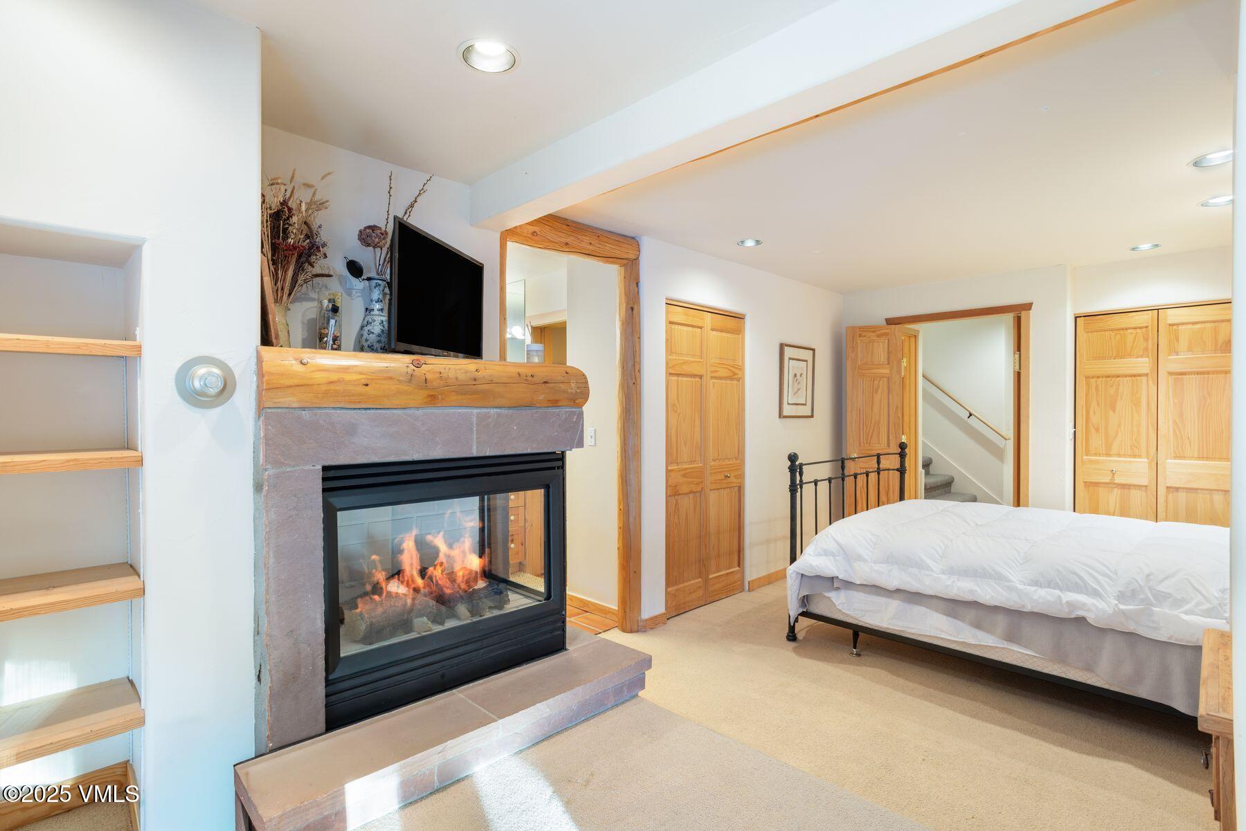 960 June Creek Road Edwards, CO 81632 - Photo 30 of 43 a bedroom with a bed and a fireplace