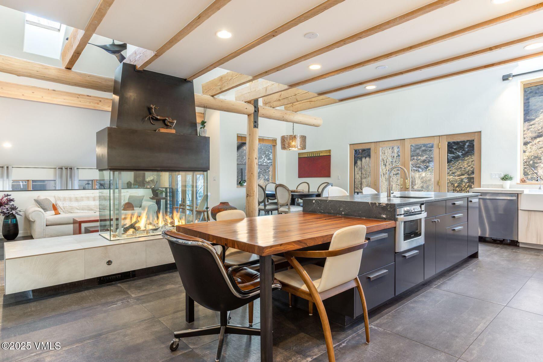 960 June Creek Road Edwards, CO 81632 - Photo 3 of 43 a dining room with a sink a counter top space and a window