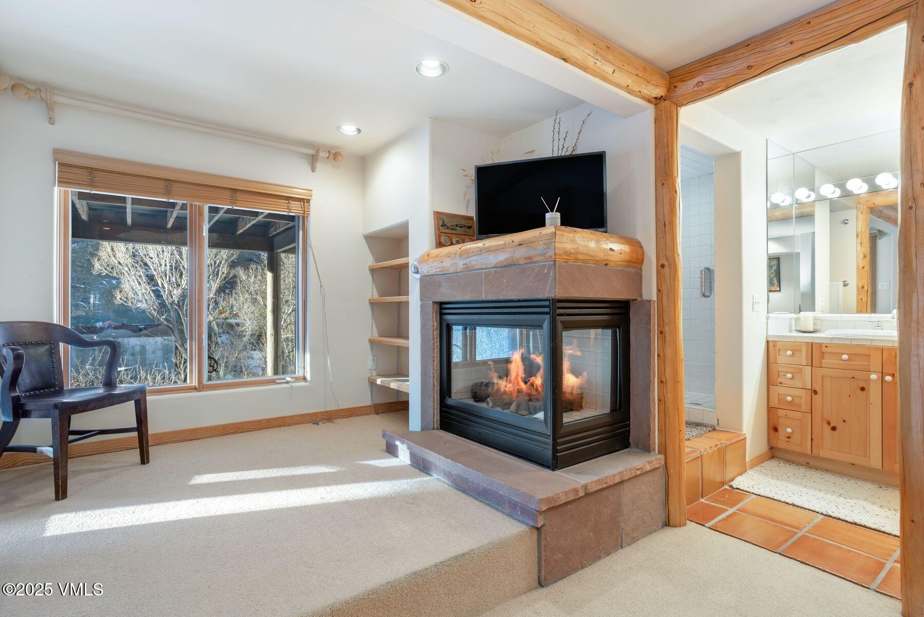 960 June Creek Road Edwards, CO 81632 - Photo 31 of 43 a living room with furniture a flat screen tv and a fireplace