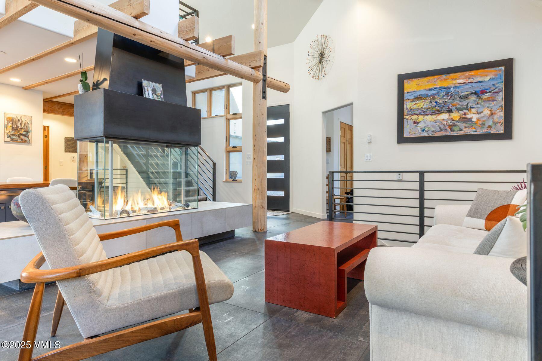 960 June Creek Road Edwards, CO 81632 - Photo 4 of 43 a living room with furniture a large window and wooden floor