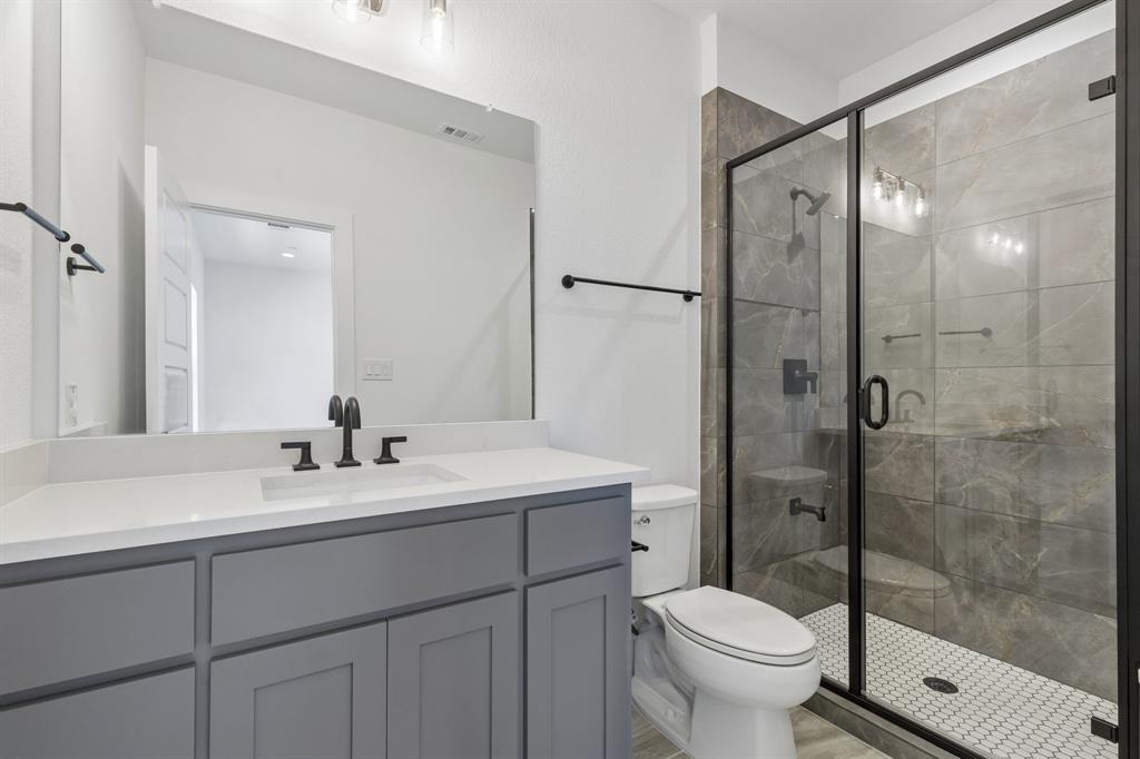 460 Harrison Lane Prosper, TX 75078 - Photo 25 of 40 Secondary downstairs bathroom, gray vanity with a white countertop and undermount sink