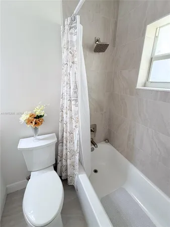 a bathroom with a toilet and a bathtub
