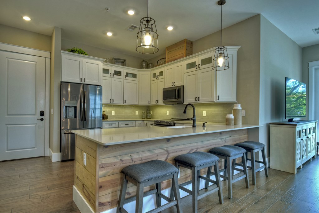 4 A Blue Ridge Street Blue Ridge, GA 30513 - Photo 15 of 31 a large kitchen with kitchen island a table and chairs in it