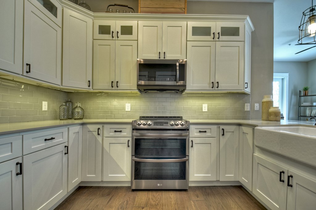 4 A Blue Ridge Street Blue Ridge, GA 30513 - Photo 18 of 31 a kitchen with stainless steel appliances granite countertop a stove and white cabinets