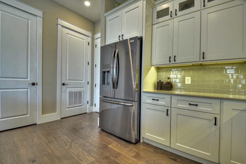 4 A Blue Ridge Street Blue Ridge, GA 30513 - Photo 19 of 31 a kitchen with stainless steel appliances white cabinets and wooden floors