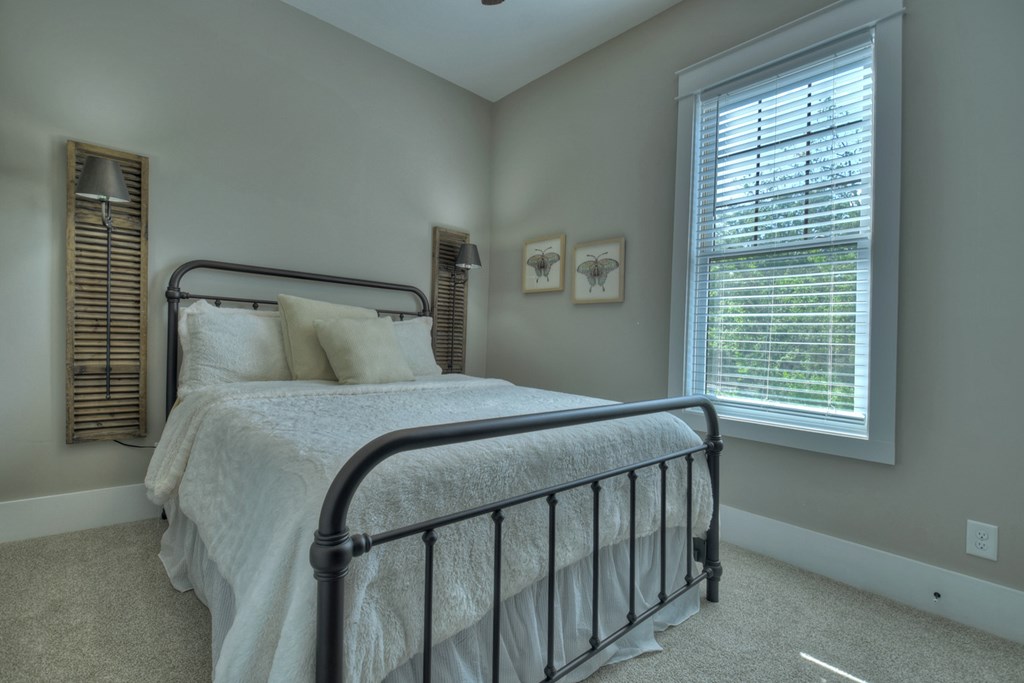 4 A Blue Ridge Street Blue Ridge, GA 30513 - Photo 22 of 31 a bedroom with a bed and a window