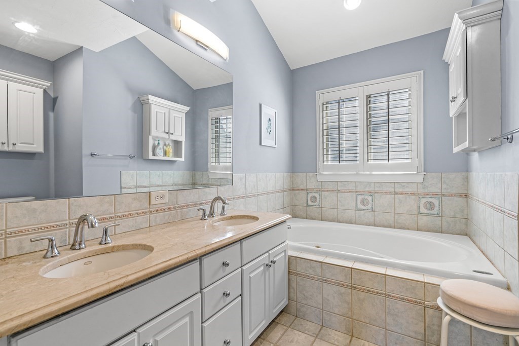 20 Walnut Street Needham, MA 02492 - Photo 14 of 27 a bathroom with a granite countertop tub sink and mirror