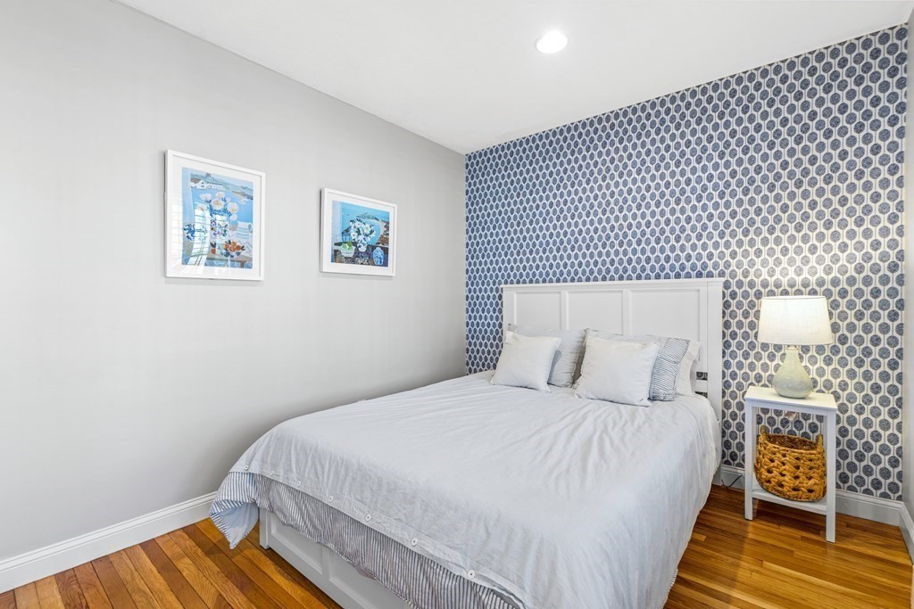 20 Walnut Street Needham, MA 02492 - Photo 18 of 27 a bedroom with a bed and wooden floor