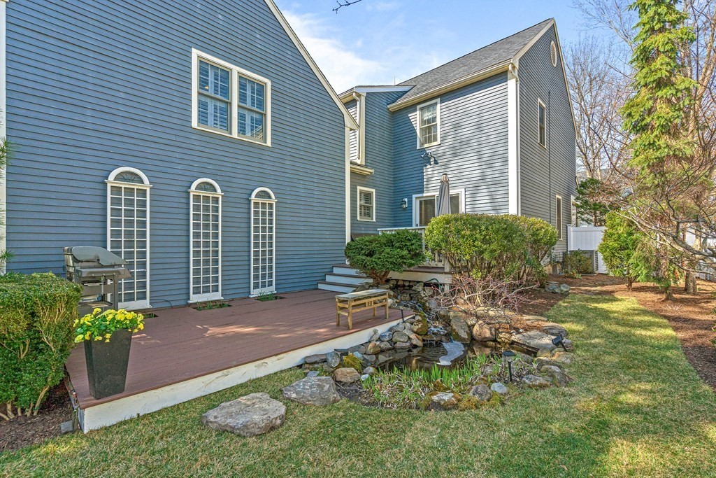20 Walnut Street Needham, MA 02492 - Photo 24 of 27 a view of a backyard with plants and a bench