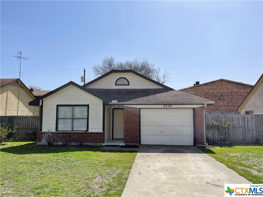 2239 Hilltop Loop Killeen, TX 76549 - Photo 1 of 1 a front view of a house with garden