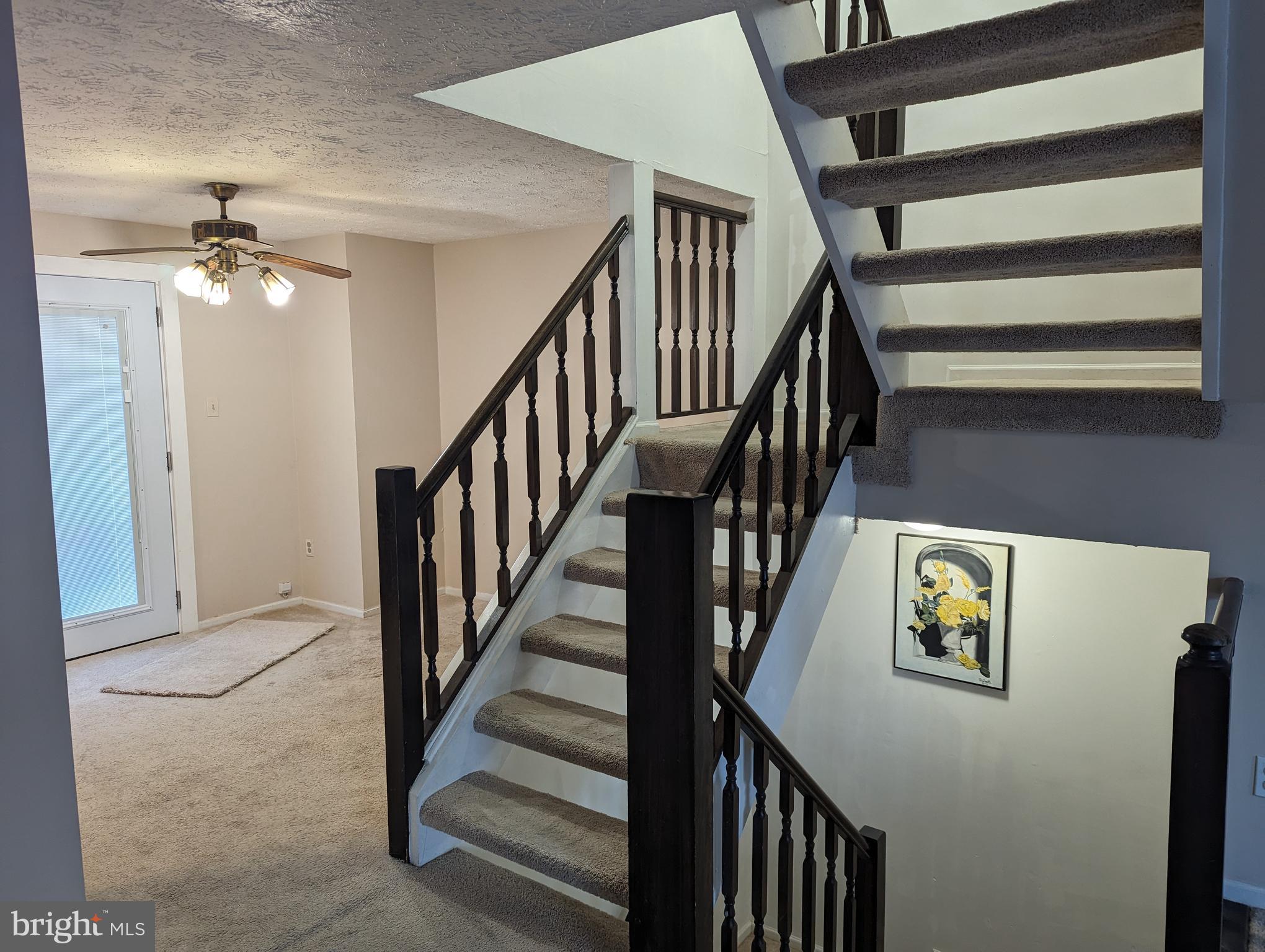 9119 Aspenpark Court Lorton, VA 22079 - Photo 13 of 32 a view of staircase with lots of frames on wall and a window