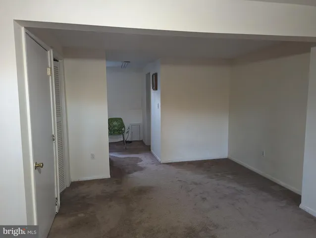 a view of a livingroom with an empty space and a ceiling fan