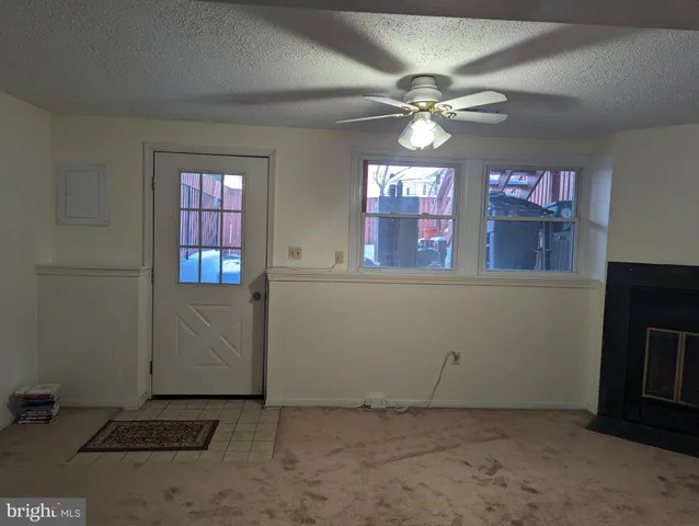 a view of a street with wooden fence