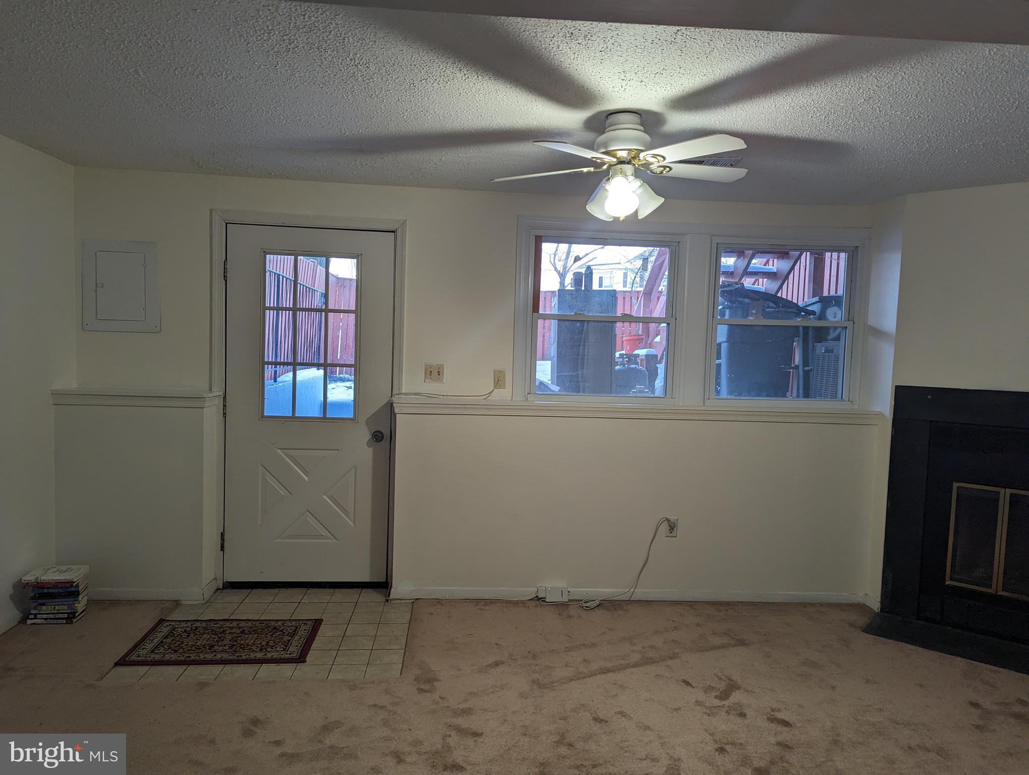 9119 Aspenpark Court Lorton, VA 22079 - Photo 24 of 32 an empty room with windows and fan