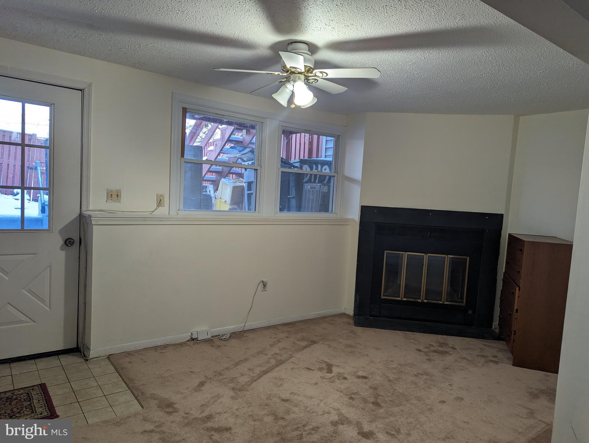 9119 Aspenpark Court Lorton, VA 22079 - Photo 25 of 32 a view of a livingroom with an empty space and a ceiling fan