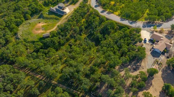 an aerial view of residential houses with outdoor space
