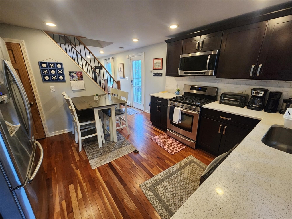 57 Green Street Marblehead, MA 01945 - Photo 1 of 29 a kitchen with stainless steel appliances granite countertop a refrigerator stove top oven dining table and chairs