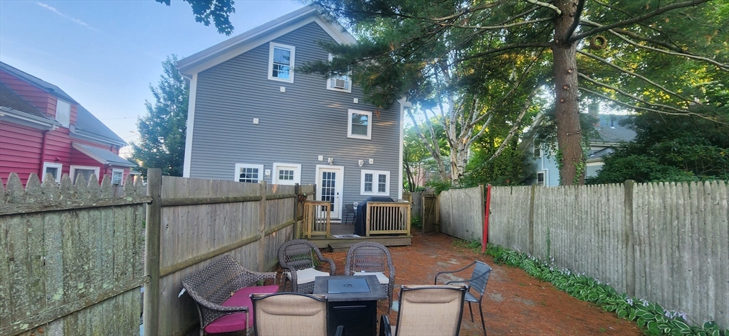 57 Green Street Marblehead, MA 01945 - Photo 18 of 29 a view of a patio with couches chairs potted plants and a palm tree