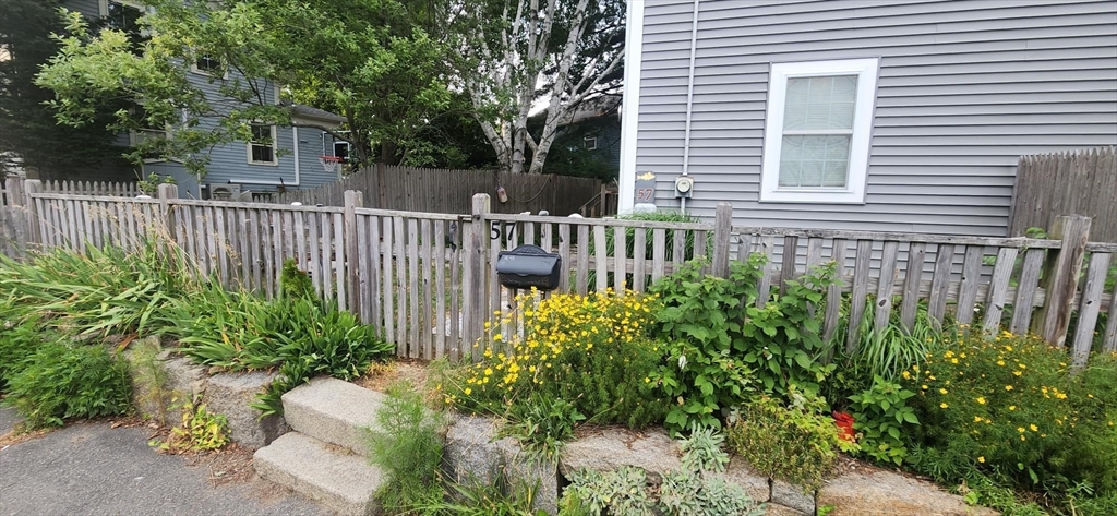 57 Green Street Marblehead, MA 01945 - Photo 22 of 29 a view of a house with a small yard and plants