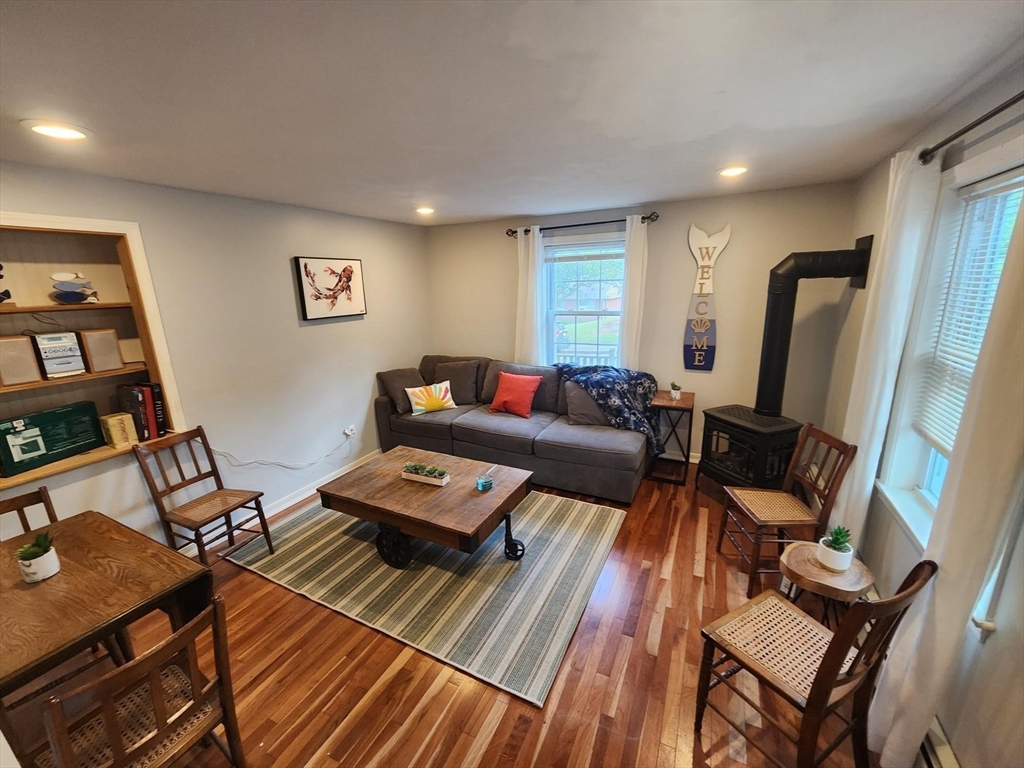 57 Green Street Marblehead, MA 01945 - Photo 4 of 29 a living room with furniture and a flat screen tv
