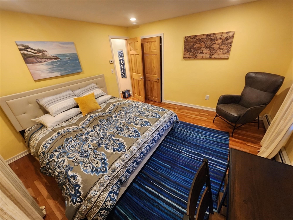 57 Green Street Marblehead, MA 01945 - Photo 8 of 29 a bedroom with a bed and wooden floor