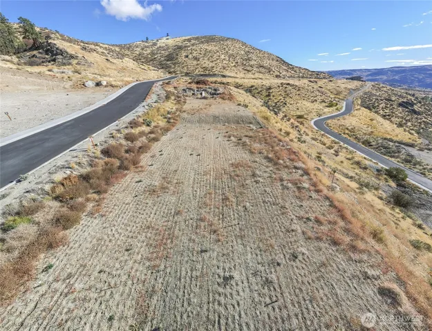 a view of a large building with mountains in the background