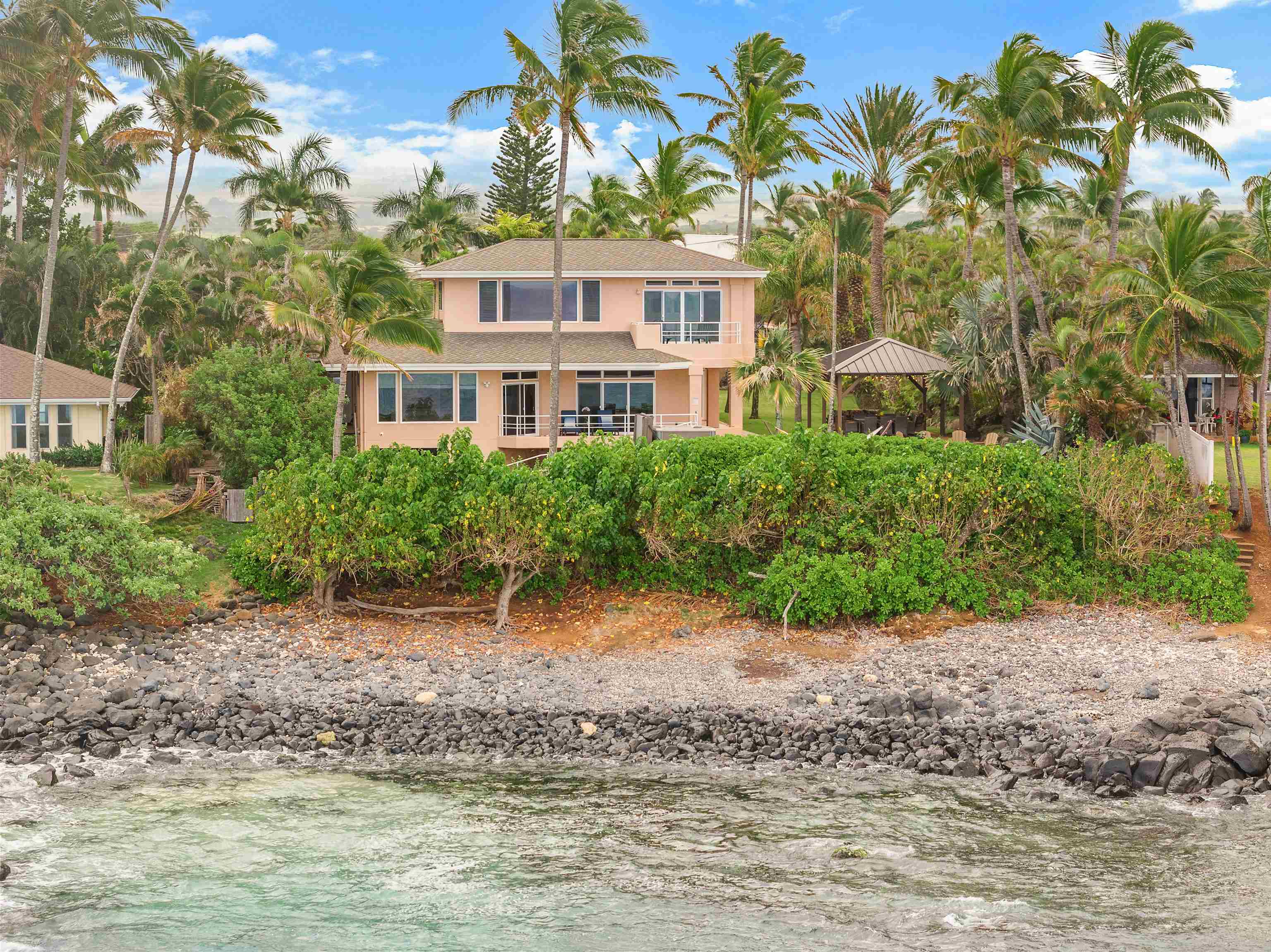 111 Aleiki Place Paia, HI 96779 - Photo 11 of 50 a front view of a house with a yard and potted plants