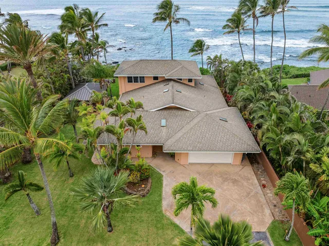 an aerial view of a house with a yard