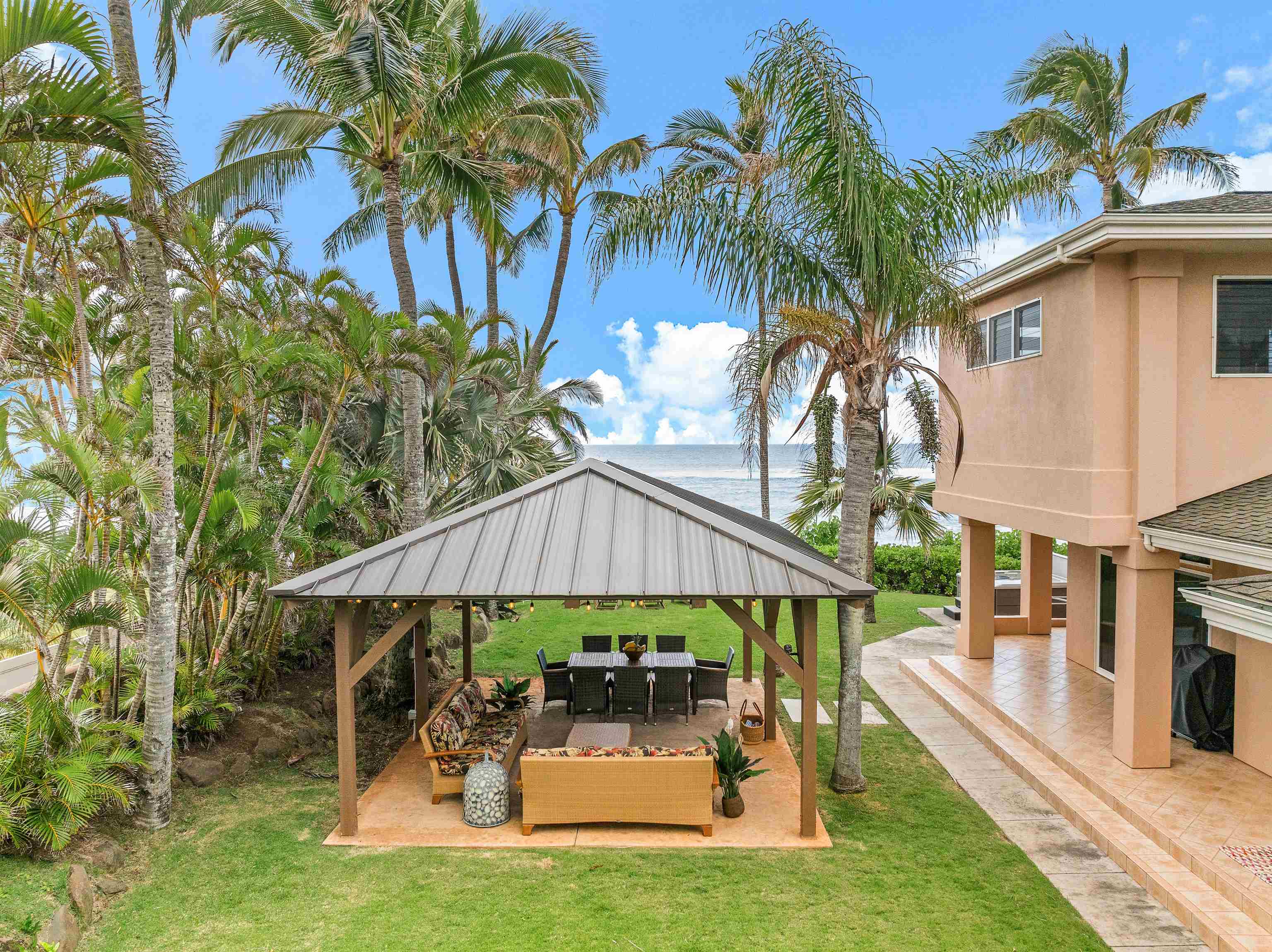 111 Aleiki Place Paia, HI 96779 - Photo 17 of 50 a patio with a table and chairs under an umbrella