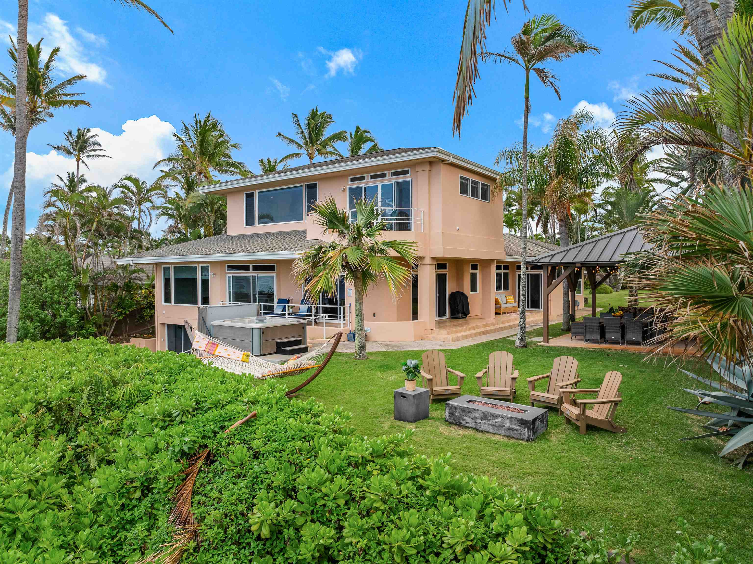 111 Aleiki Place Paia, HI 96779 - Photo 20 of 50 a front view of a house with garden and sitting area