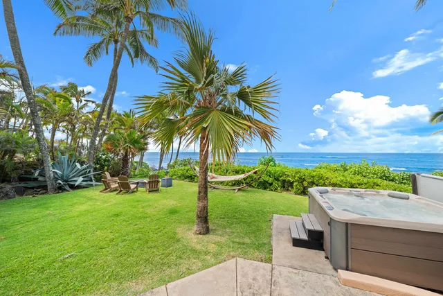 a view of a backyard with a garden and entertaining space