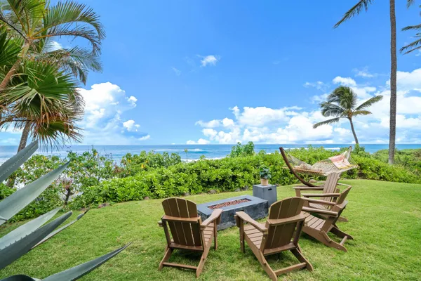 a view of backyard with seating space and trees